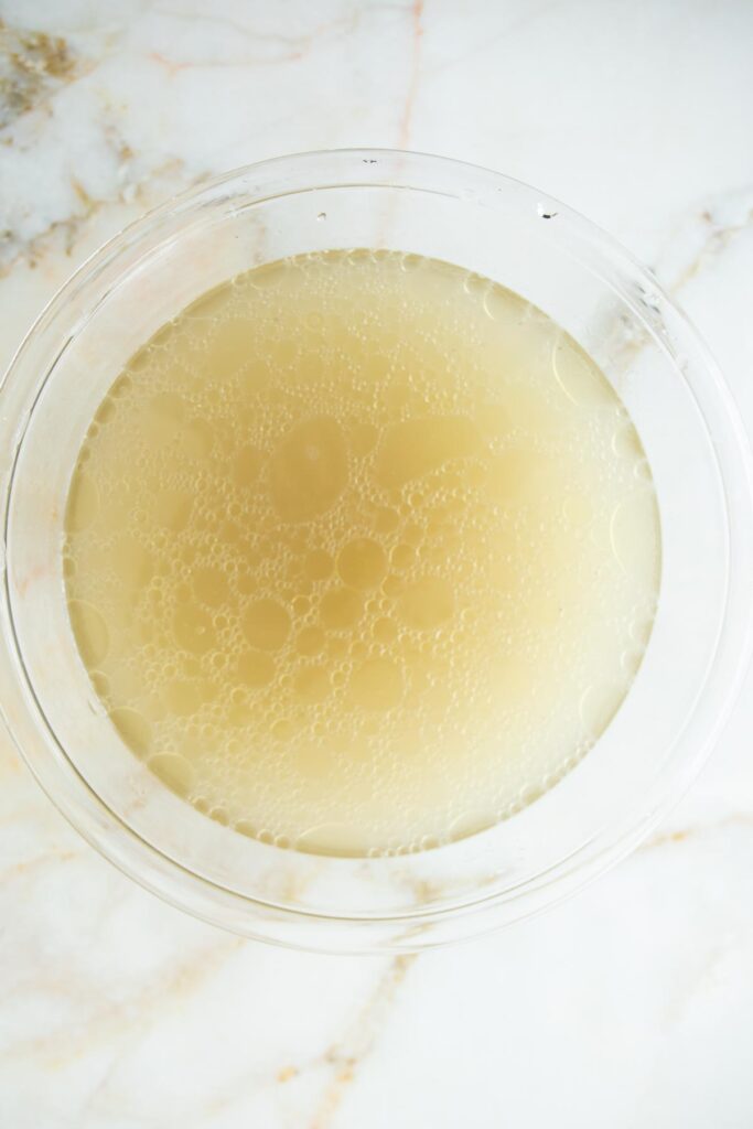 chicken broth in a clear glass bowl