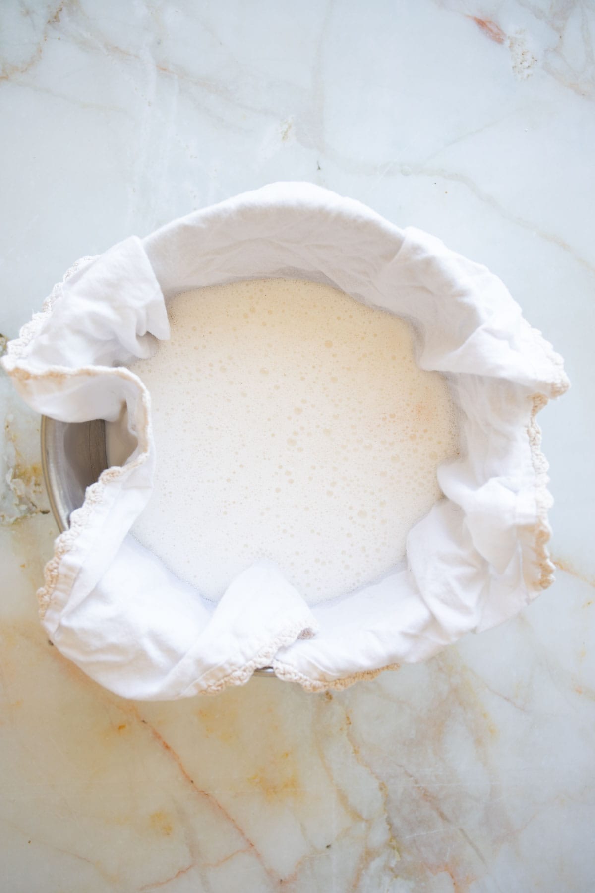 pour the almond milk on the cotton fabric