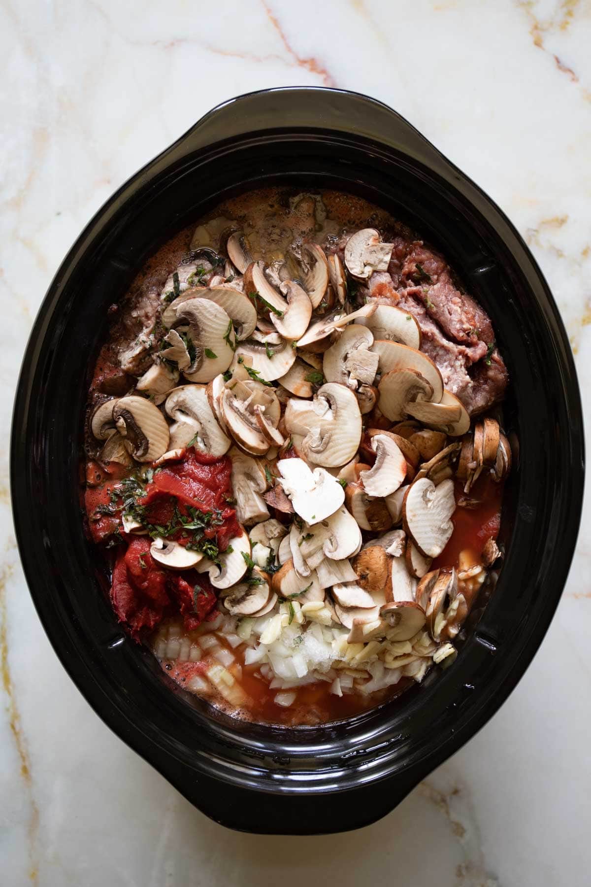 ingredients for slow cooker spaghetti sauce in a slow cooker