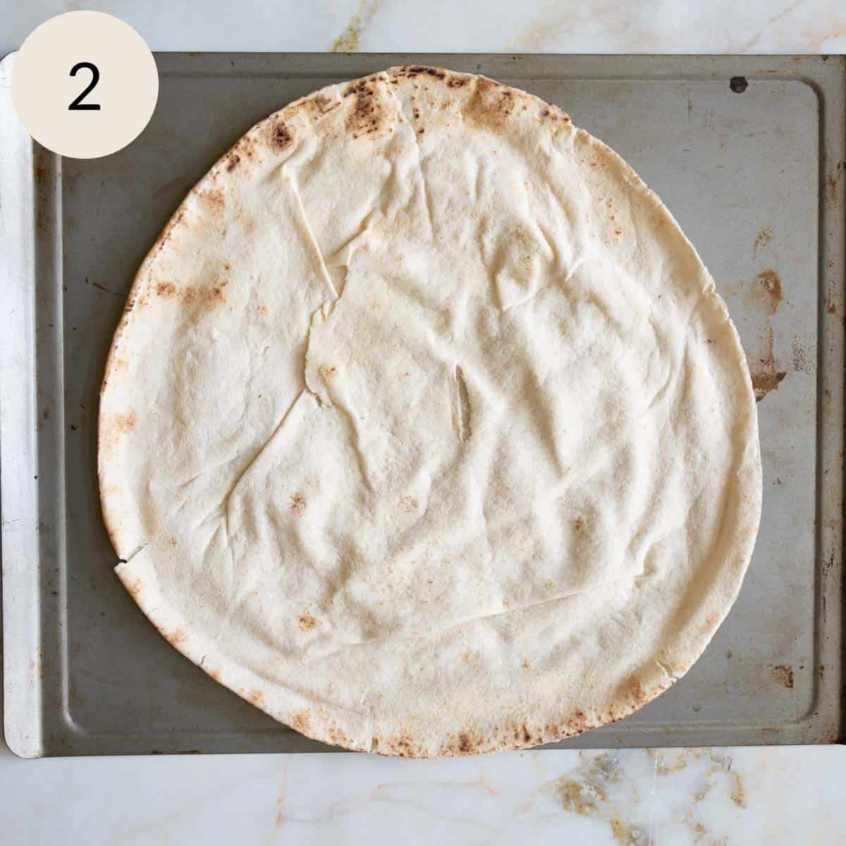 a Lebanese pita bread on a baking sheet