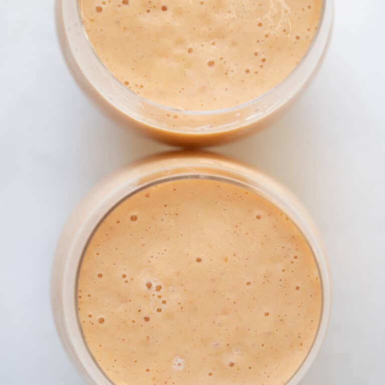 close up view of a pineapple peach and banana smoothie