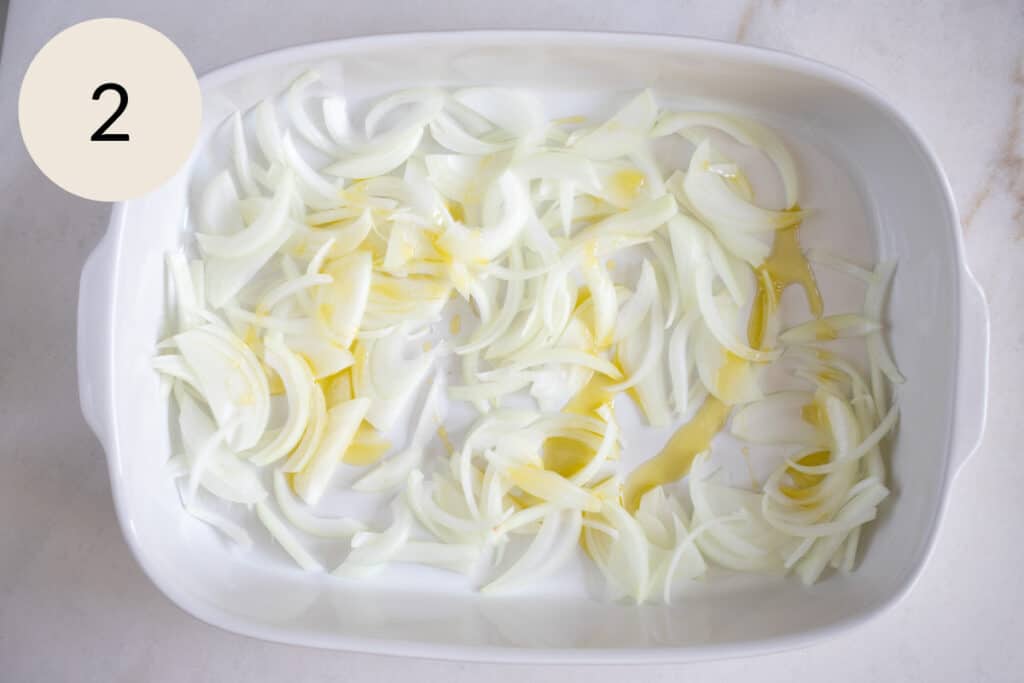olive oil and sliced onions in a baking dish
