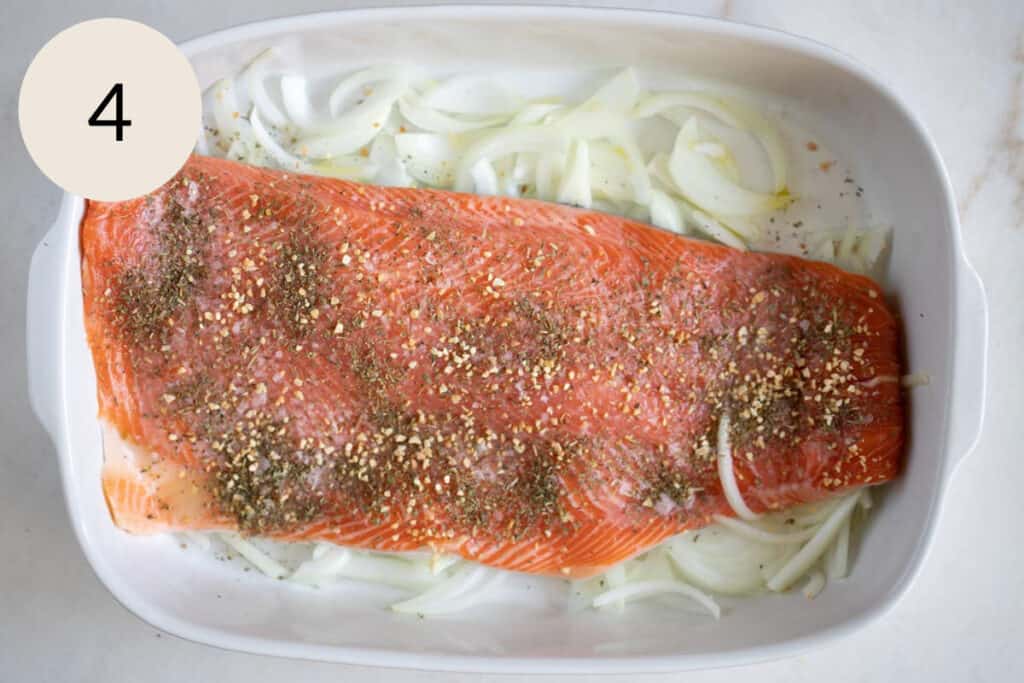adding dried Italian herb seasoning and garlic granules on the steelhead trout recipe