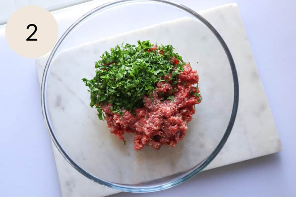 add the chopped parsley to the ground meat