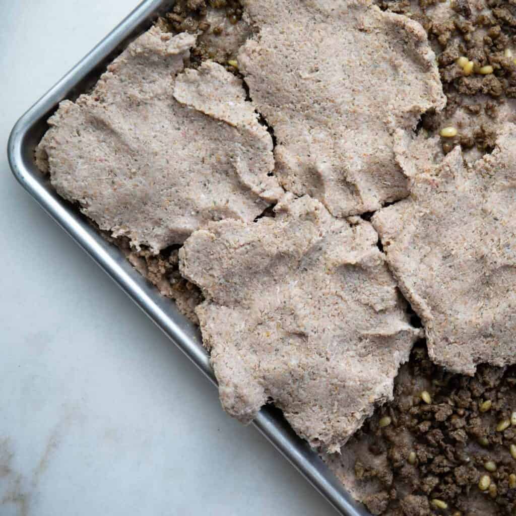add the kibbeh meat mixture on top