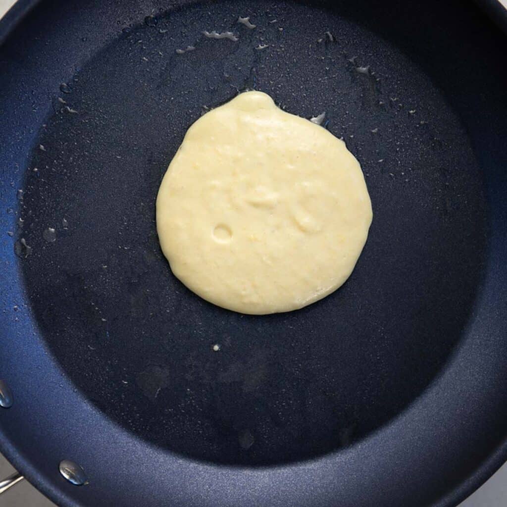 scoop ¼ cup pancake batter into a greased pan