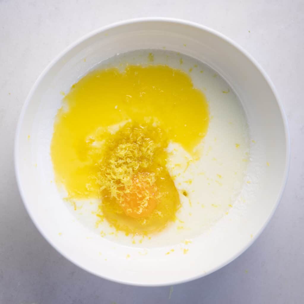 a bowl with butter, buttermilk, lemon zest, and an egg