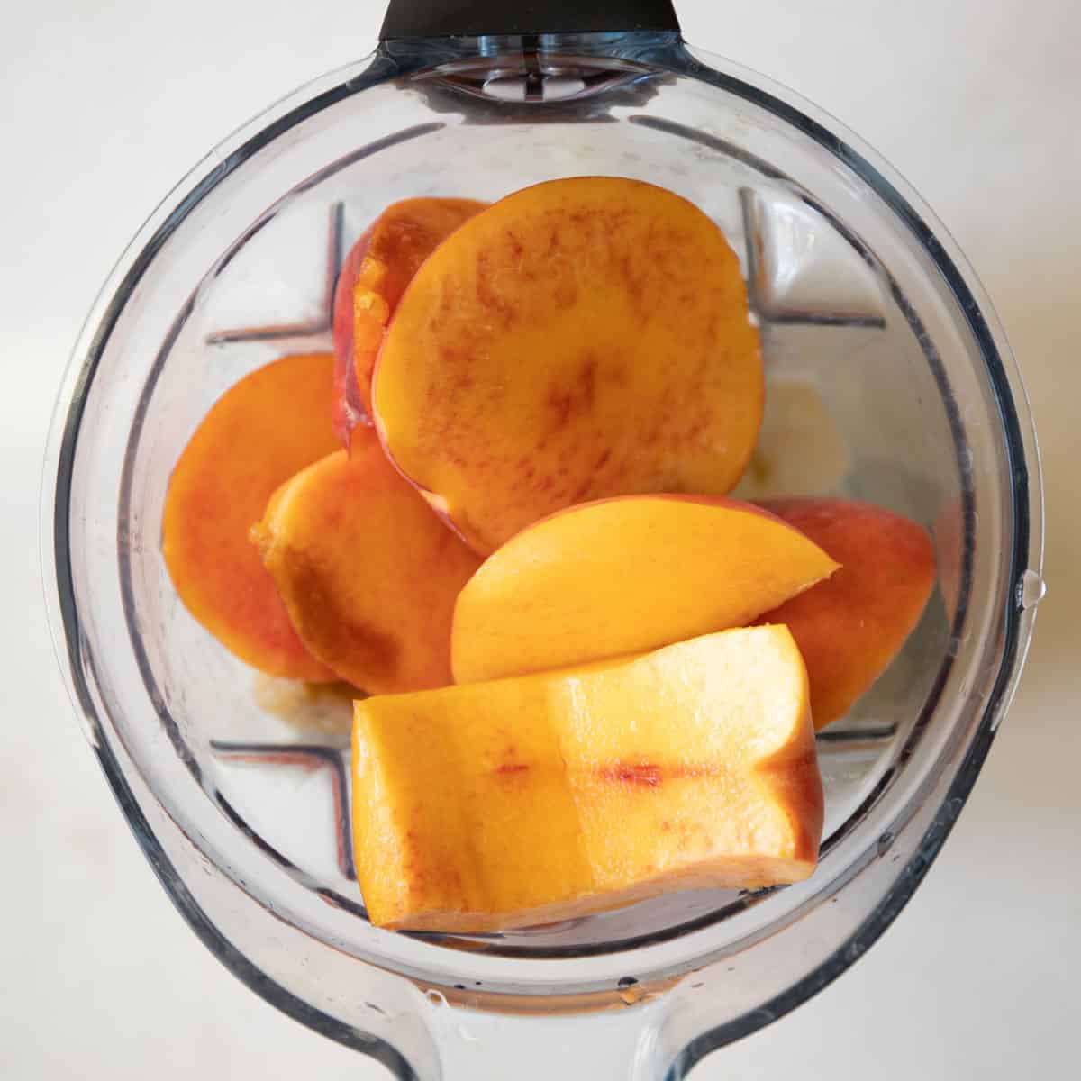 peach smoothie ingredients in a blender