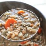 lentil soup adas bi hamod in a spoon.
