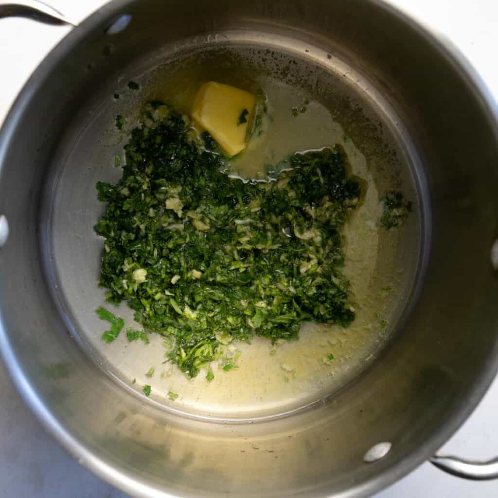 frying the cilantro and garlic in butter and oil