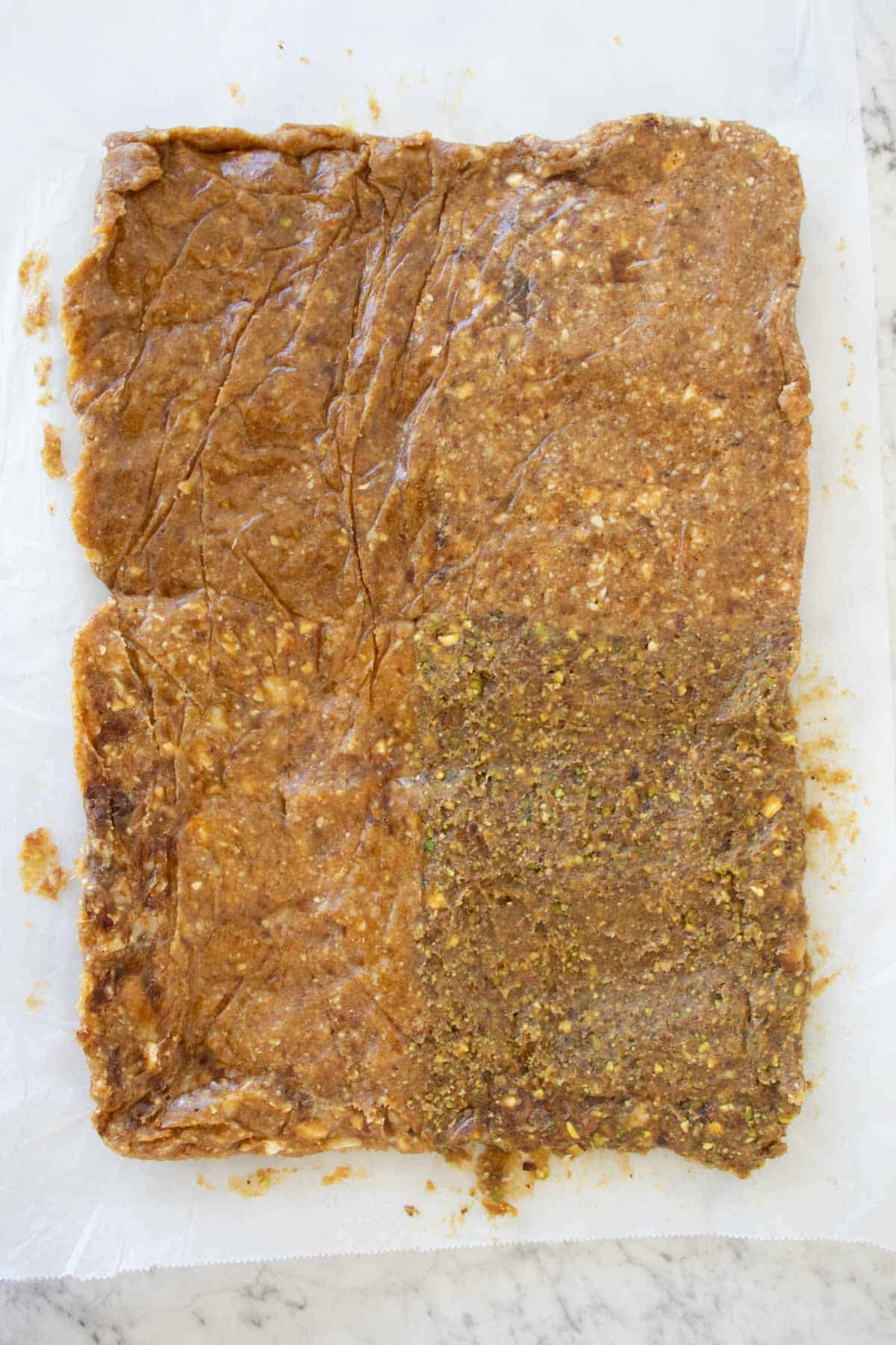 larabar mixture pressed flat on a parchment paper