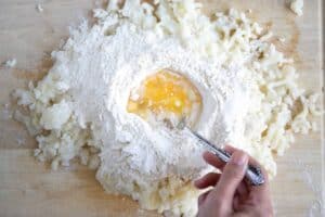 A bag of store-bought potato gnocchi next to a bowl of homemade gnocchi