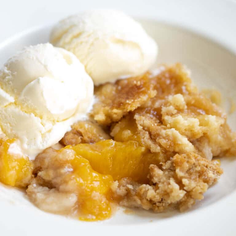canned peach cobbler with cake mix and scoops of ice cream.