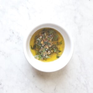 lemon garlic butter with freshly chopped herbs in a small bowl.