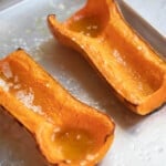 roasted butternut squash halves on a baking sheet
