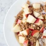 Apples and granola on top of cinnamon maple greek yogurt.