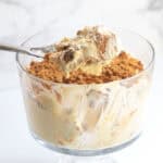 biscoff banana pudding being scooped out of the trifle dessert bowl.