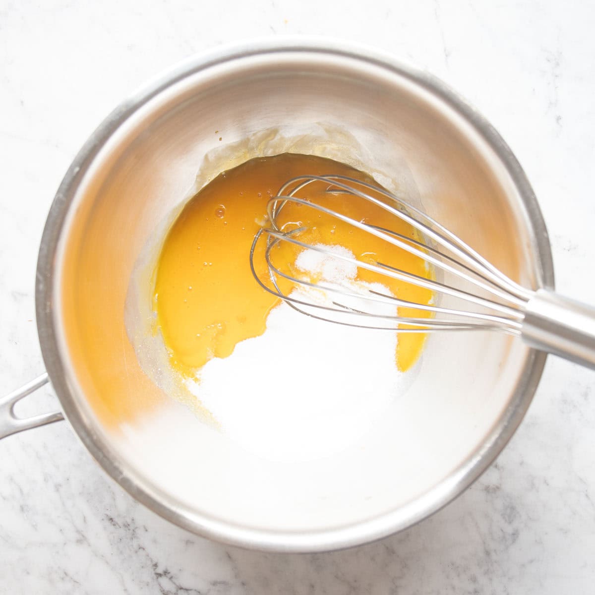 egg yolks and sugar in a bowl.