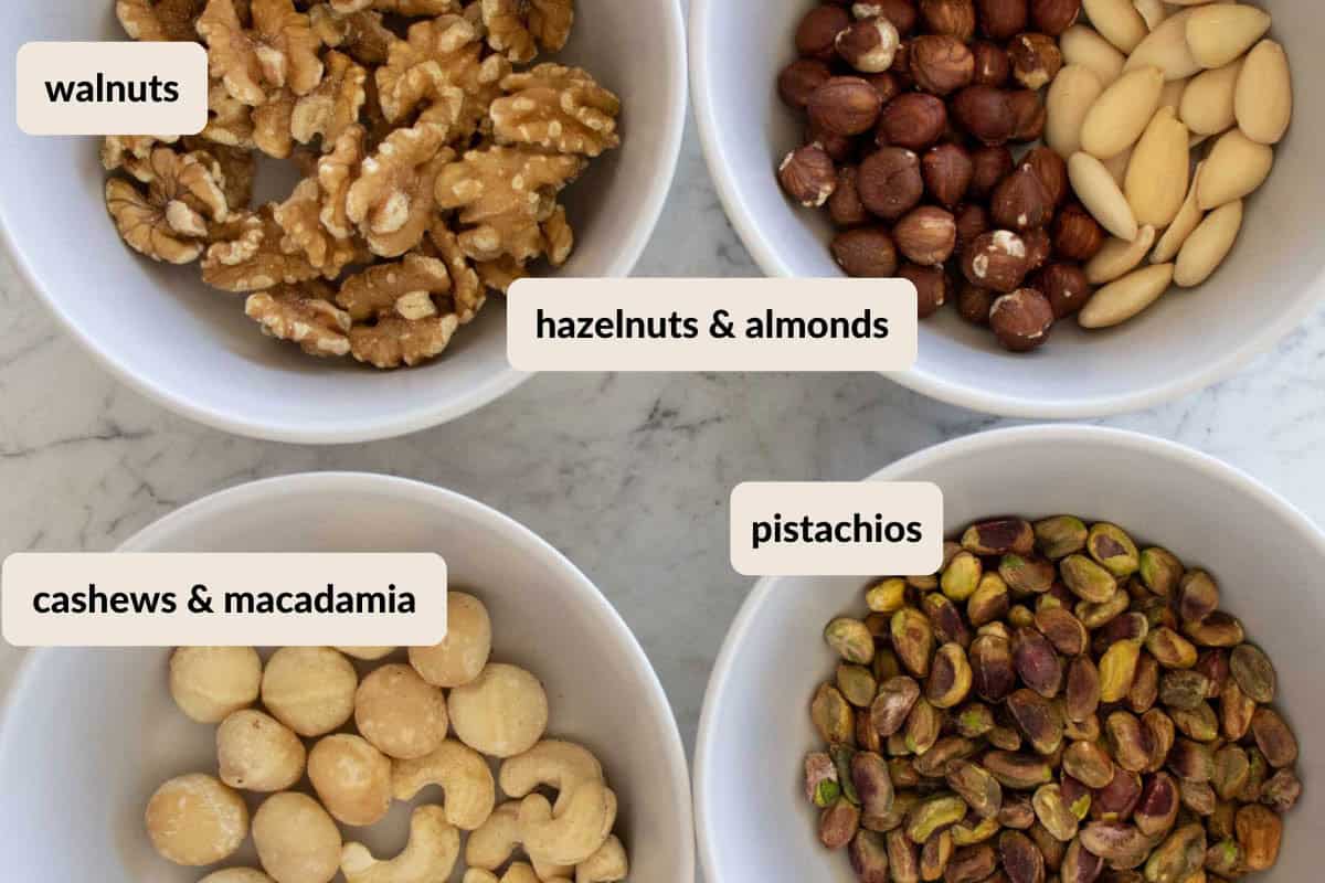 different nut variations for homemade larabars. The nuts include walnuts, cashews, macadamia nuts, hazelnuts, almonds, and pistachios.
