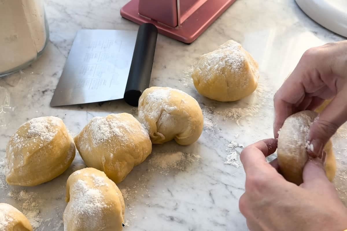 pressing the pasta dough with flour.