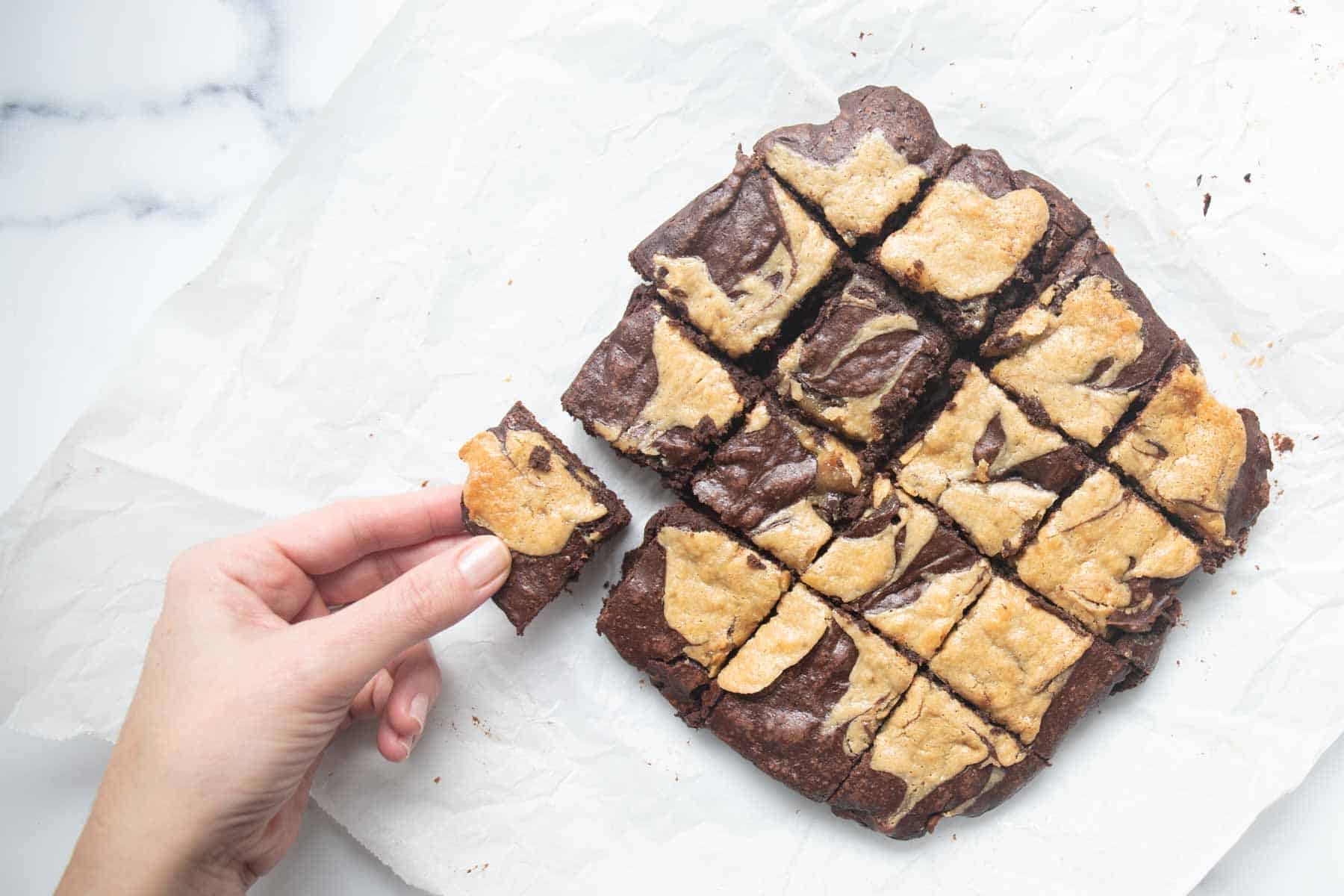 grabbing a tahini brownie piece.