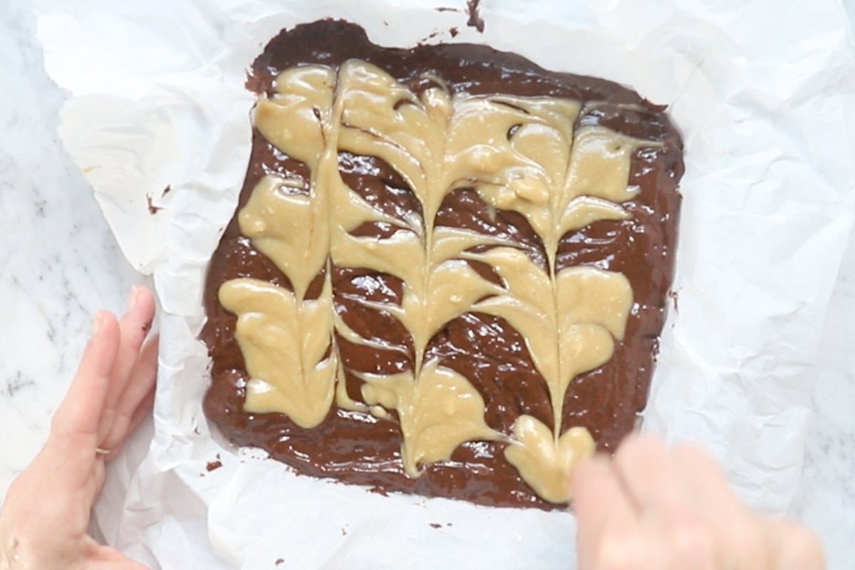 using a toothpick to spread the tahini mixture.