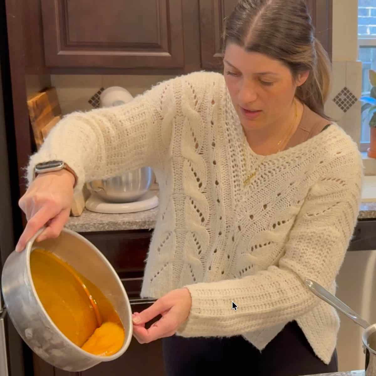 Lily swirling the caramel around the cake pan.