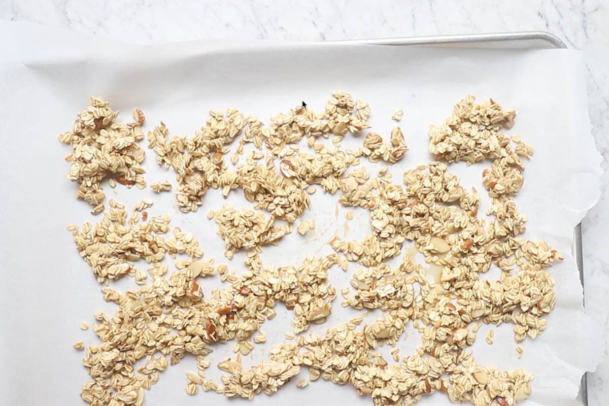 spreading the granola mixture on a baking sheet.