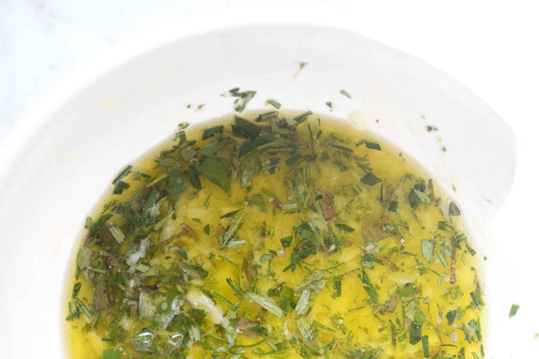 homemade mediterranean lemon chicken marinade with crushed garlic.