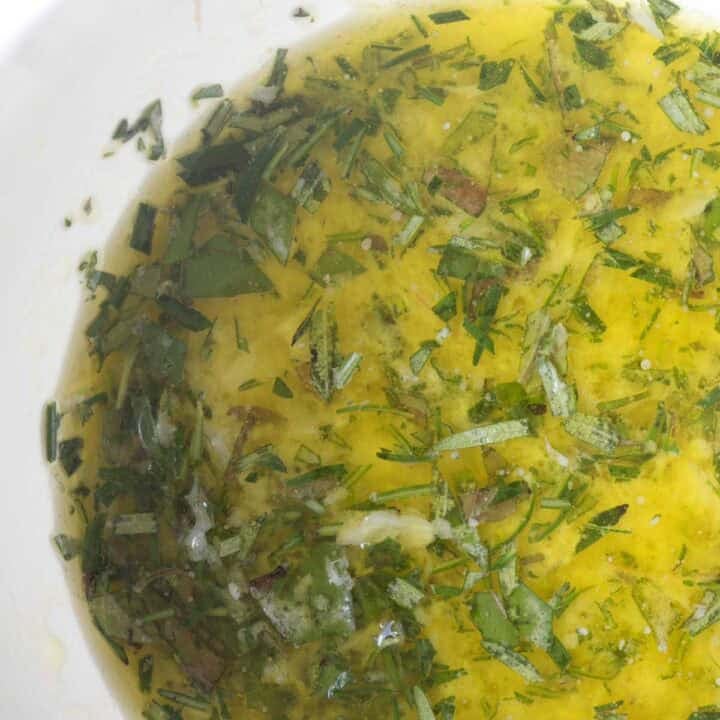 homemade mediterranean lemon chicken marinade with crushed garlic and fresh herbs.