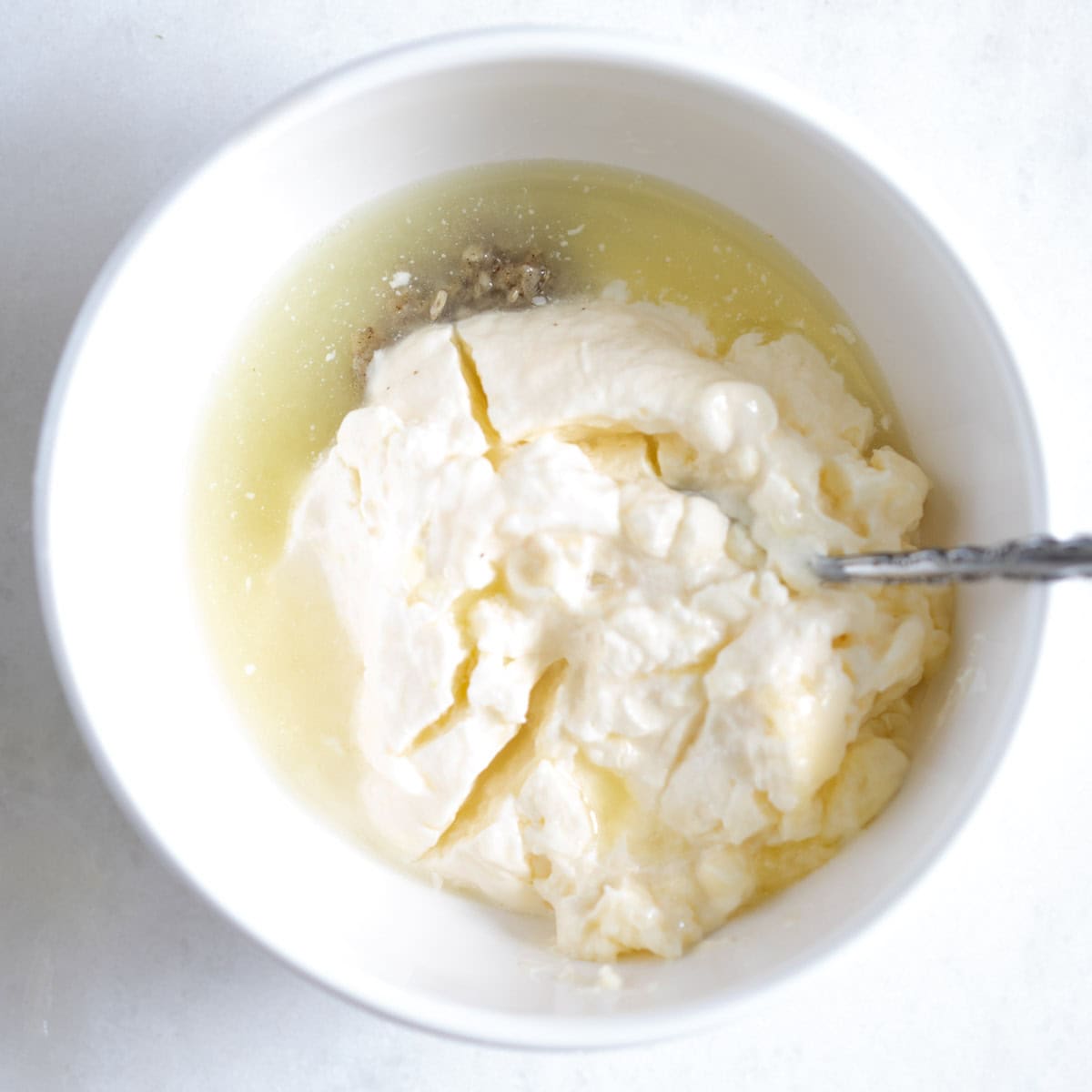 mixing the aioli sauce in a bowl.