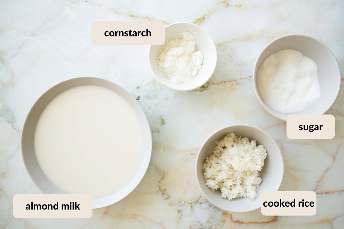 almond milk rice pudding ingredients showing cooked rice, almond milk, cornstarch, and sugar.